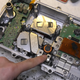 The inside of a Renault Zoe DC/DC converter & charge module. Next to Mike’s finger is a large capacitor in orange, and the two vaguely rectangular metal objects in between the two green circuit boards are inductors - almost the size of your fist.